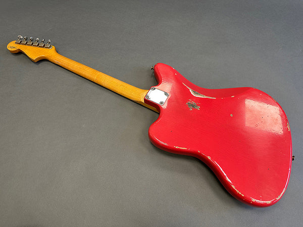 Red vintage electric guitar with worn finish and maple neck showing back side on gray background
