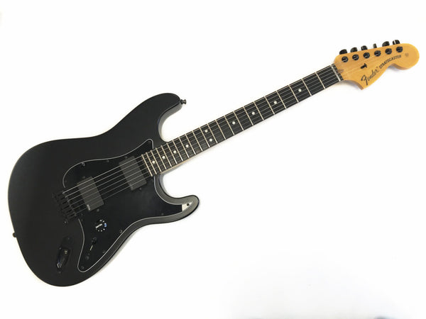 Black Fender Stratocaster electric guitar with rosewood fretboard and two humbucker pickups, maple headstock with Fender logo, vintage style tuning pegs, and black pickguard on white background.