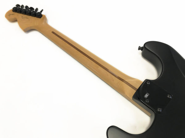 Back view of electric guitar showing maple neck with walnut center stripe and black tuning pegs against white background