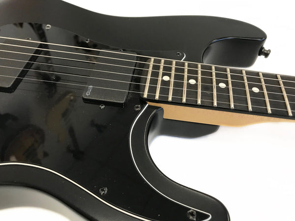 Close-up of black electric guitar body and fretboard with EMG pickups and white dot inlays on dark wood fingerboard