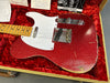 Vintage Fender Telecaster electric guitar in red sparkle finish with white pickguard, maple neck, and aging wear, displayed in red plush-lined case with Fender documentation and owner's manual.