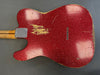 Vintage red sparkle finish electric guitar body with visible wear and aging, string ferrules, and maple neck heel plate on gray background