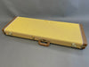 Hard-shell guitar case with yellow textured exterior and brown leather corner reinforcements on gray background