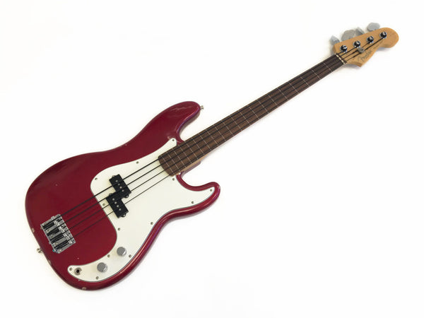 Red Fender Precision Bass guitar with white pickguard and rosewood fretboard on white background