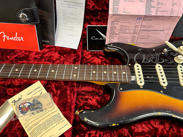 Fender vintage sunburst Stratocaster electric guitar with rosewood fretboard in red velvet case, showing checklist, Fender owner's manual, tremolo springs and inspection documents