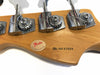 Close-up of Fender guitar headstock with vintage style tuning pegs and 50 years of excellence badge, serial number N6147659 on natural wood finish