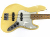 Yellow electric bass guitar with white pickguard and black control knobs, maple fretboard, and chrome bridge on white background