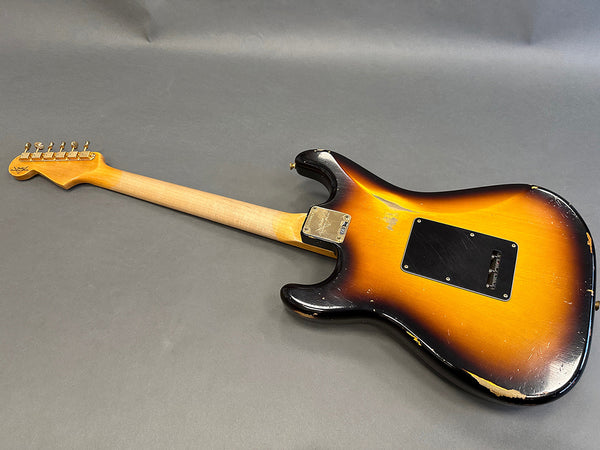 Vintage sunburst electric guitar with worn finish, showing backside and neck on gray background at Coffee House Guitars