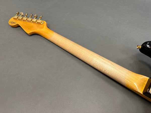 Maple neck and vintage-style gold tuning pegs on electric guitar with Coffee House Guitars logo on headstock against gray background