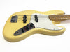 Cream-colored electric bass guitar with white pickguard, chrome control plate, and maple neck on white background
