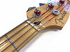 Close-up of Fender Precision Bass guitar headstock with chrome tuning pegs and steel strings against white background