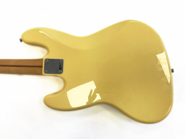 Back of cream yellow electric guitar body with bolt-on maple neck shown against white background