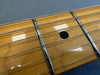 Close-up of maple guitar fretboard with metal frets and black dot inlay, steel guitar strings on Coffee House Guitars acoustic guitar neck