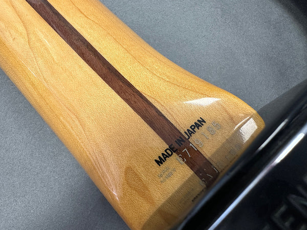 Close-up of guitar neck heel with "Made in Japan" stamp and serial number on maple wood used in Coffee House Guitars product listings