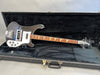 Rickenbacker electric bass guitar with four strings and triangular fret inlays in black hard guitar case interior