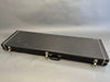 Black rectangular hard guitar case with metal latches and handle on gray background