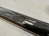 Close-up of black guitar neck back showing scratches and minor dents on glossy finish