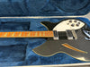 Vintage black semi-hollow electric guitar with maple neck and triangle inlays inside blue plush-lined hard case