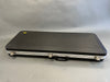 Black rectangular hard guitar case with metal latches and handle on gray background