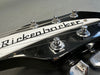 Close-up of black Rickenbacker guitar headstock with tuning pegs and strings at Coffee House Guitars product listing