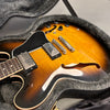Semi-hollow body electric guitar with sunburst finish and dual humbucker pickups in protective guitar case with plush lining