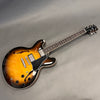 Gibson ES-335 electric guitar with sunburst finish, maple top, dual humbucker pickups, semi-hollow body, and rosewood fretboard.