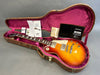 Gibson Les Paul electric guitar sunburst finish with case and warranty documents laid out on gray surface