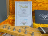 Fender Custom Shop Certificate of Authenticity for 60 Stratocaster LCC with signed director's name, displayed inside yellow plush guitar case alongside Fender Custom Shop Custom Care booklet and Fender Stratocaster guitar headstock.