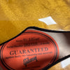 Close-up of Gibson ES-335 guitar label inside the body showing model, serial number, and warranty guarantee against faulty workmanship and materials.