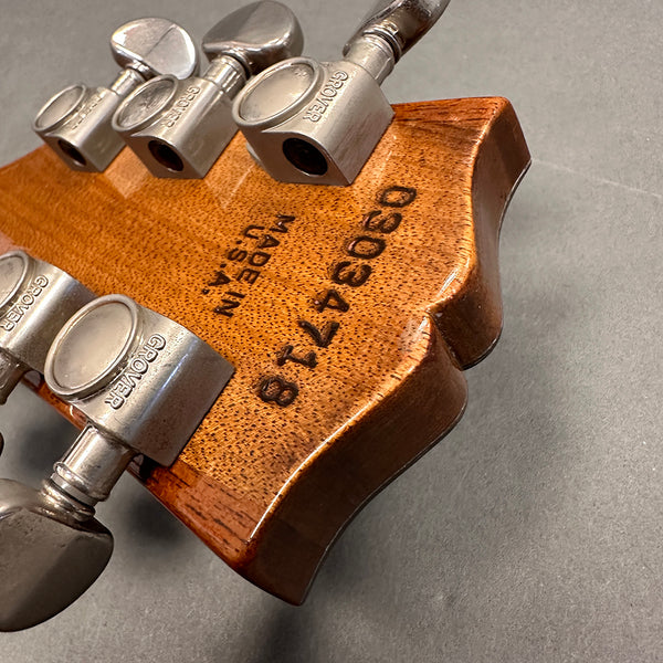Close-up of vintage guitar headstock back showing Grover tuning pegs, serial number 0303478, and Made in USA stamp on natural wood finish