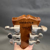 Close-up of guitar headstock back showing serial number 03034719, Made in USA stamp, and six Grover tuning pegs on natural wood finish guitar neck