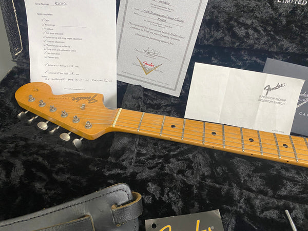 Fender Stratocaster guitar headstock and neck with maple fretboard inside a black plush guitar case, accompanied by Fender certification and setup documents from Coffee House Guitars.