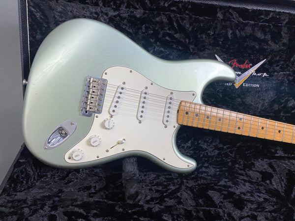 Fender Stratocaster electric guitar in seafoam green finish with maple fretboard, three single-coil pickups, and white pickguard in black plush guitar case, Fender Custom Shop limited edition logo visible