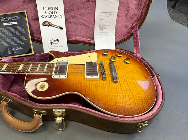 1959 Gibson Les Paul Standard 60th Anniversary electric guitar in sunburst finish with original Gibson gold warranty and certificate, displayed in a vintage pink-lined guitar case at Coffee House Guitars.