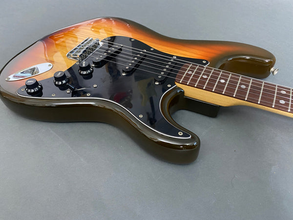 Sunburst electric guitar with black pickguard and maple neck on gray background, close-up view of body and fretboard, Coffee House Guitars product listing.