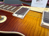 Close-up of Gibson Les Paul electric guitar body with sunburst flame maple top and chrome humbucker pickups at Coffee House Guitars