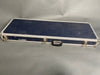 Closed vintage hard shell guitar case with blue textured exterior and metal corner reinforcements.