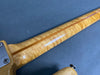 Close-up view of figured maple guitar neck with natural finish and visible wood grain pattern from Coffee House Guitars