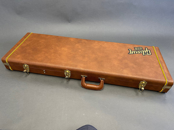 Gibson 1959 vintage style brown hardshell guitar case with gold latches and handle on grey background