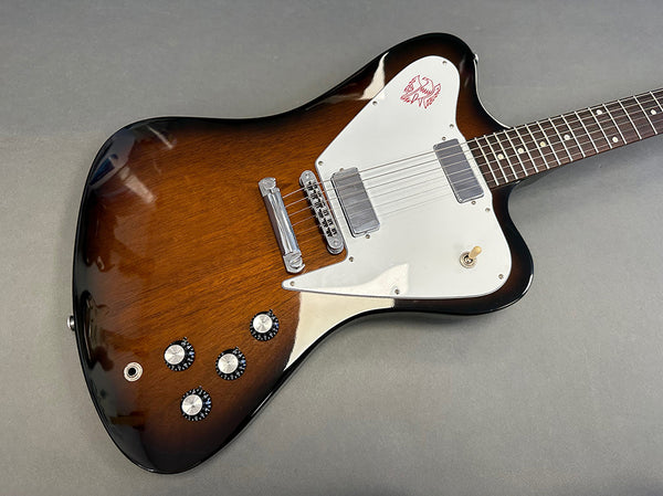 Vintage sunburst electric guitar with white pickguard and dual humbucker pickups on gray background