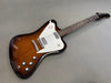 Electric guitar with sunburst finish and white pickguard featuring bird graphic, chrome hardware, and control knobs on gray background