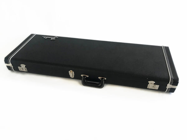 Black Fender hard shell guitar case with metal latches and handle, white stitching detail, closed on white background
