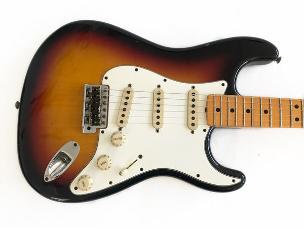 Vintage sunburst electric guitar with maple neck and white pickguard, three single coil pickups, volume and tone knobs, and chrome bridge hardware on white background