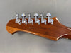 Close-up of guitar headstock with six chrome tuning pegs on mahogany wood, serial number visible on the back, Coffee House Guitars product image