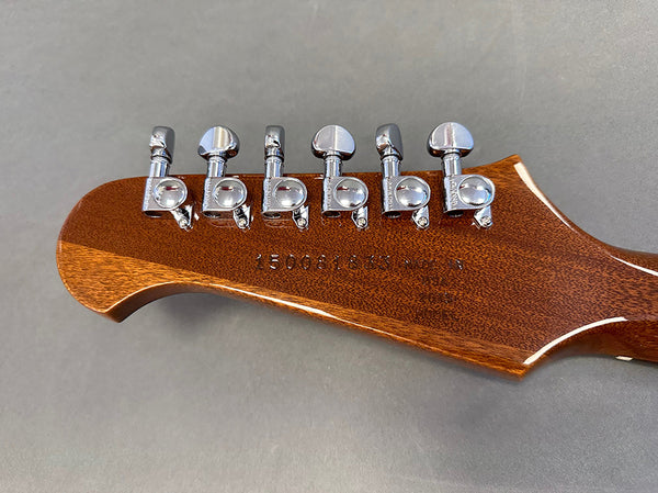 Close-up of guitar headstock with six chrome tuning pegs on mahogany wood, serial number visible on the back, Coffee House Guitars product image