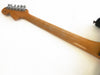 Back view of electric guitar neck with natural wood finish and chrome tuning pegs on white background