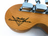 Close-up of Fender Custom Shop guitar headstock with tuning pegs and logo on natural wood finish