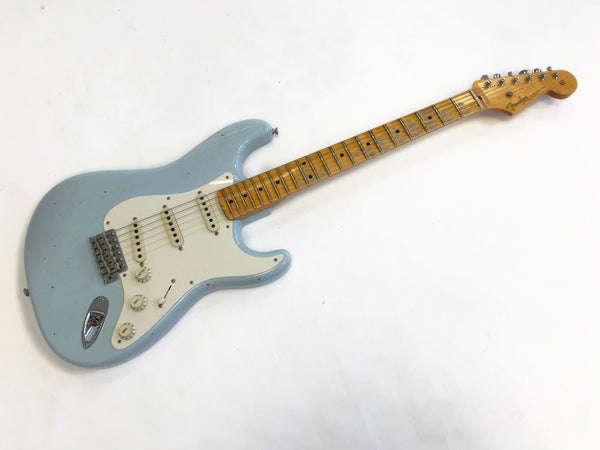Fender Stratocaster electric guitar in light blue with white pickguard and maple neck on white background