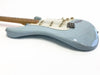Light blue electric guitar with white pickguard and maple neck, vintage style with single-coil pickups and tremolo bridge, shown on white background