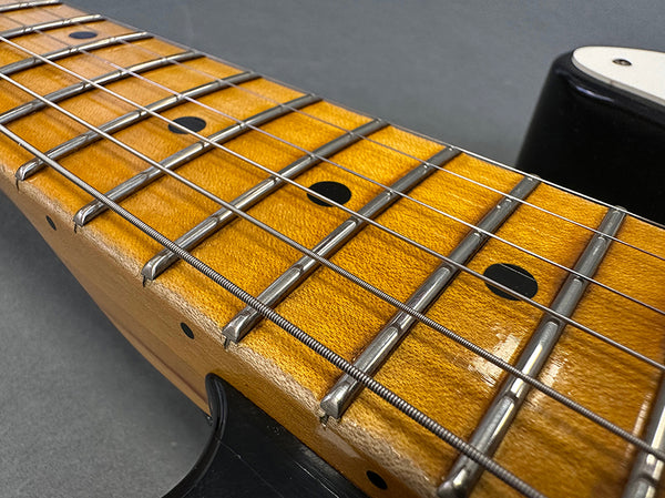 Close-up of electric guitar maple fretboard with metal frets and steel strings on Coffee House Guitars product listing